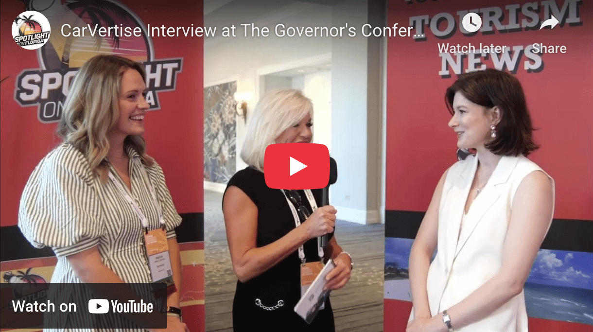 Three women talking at a conference.