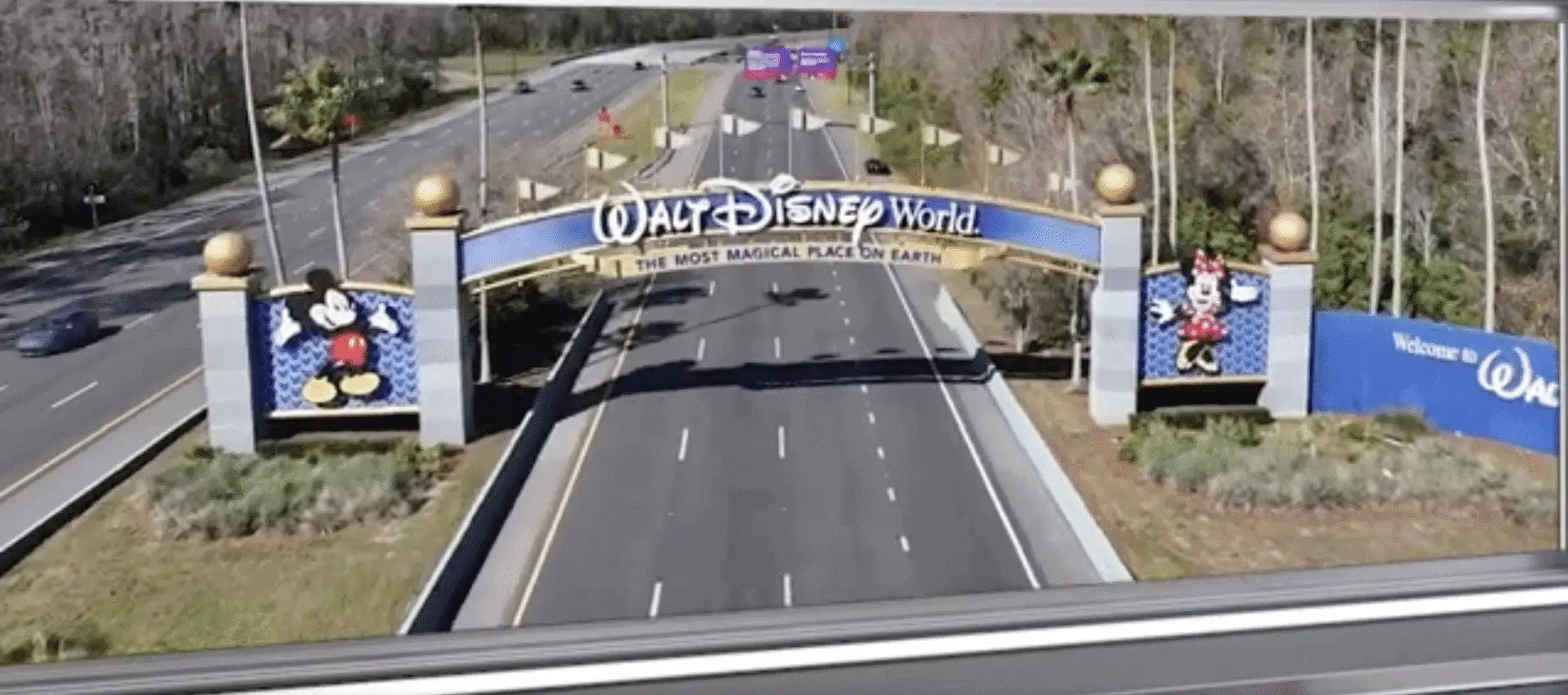 Walt Disney World entrance sign over road.