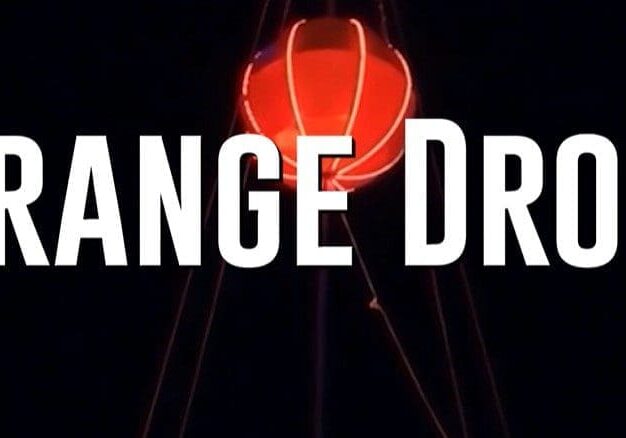 A red light that is lit up and the words " orange drop ".