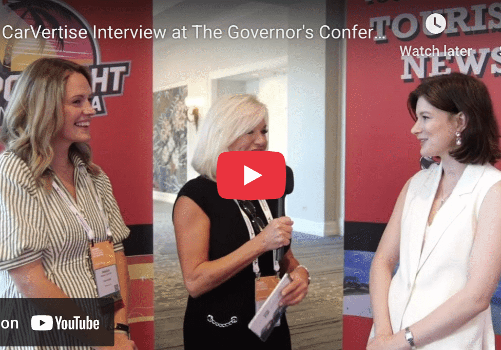 Three women talking at a conference.