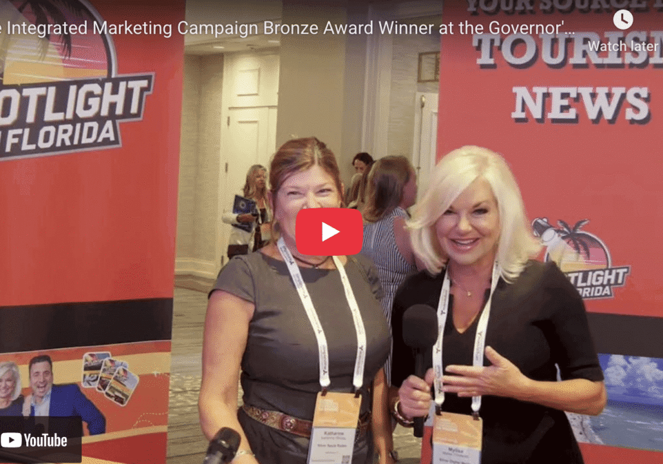 Two women posing at marketing event.