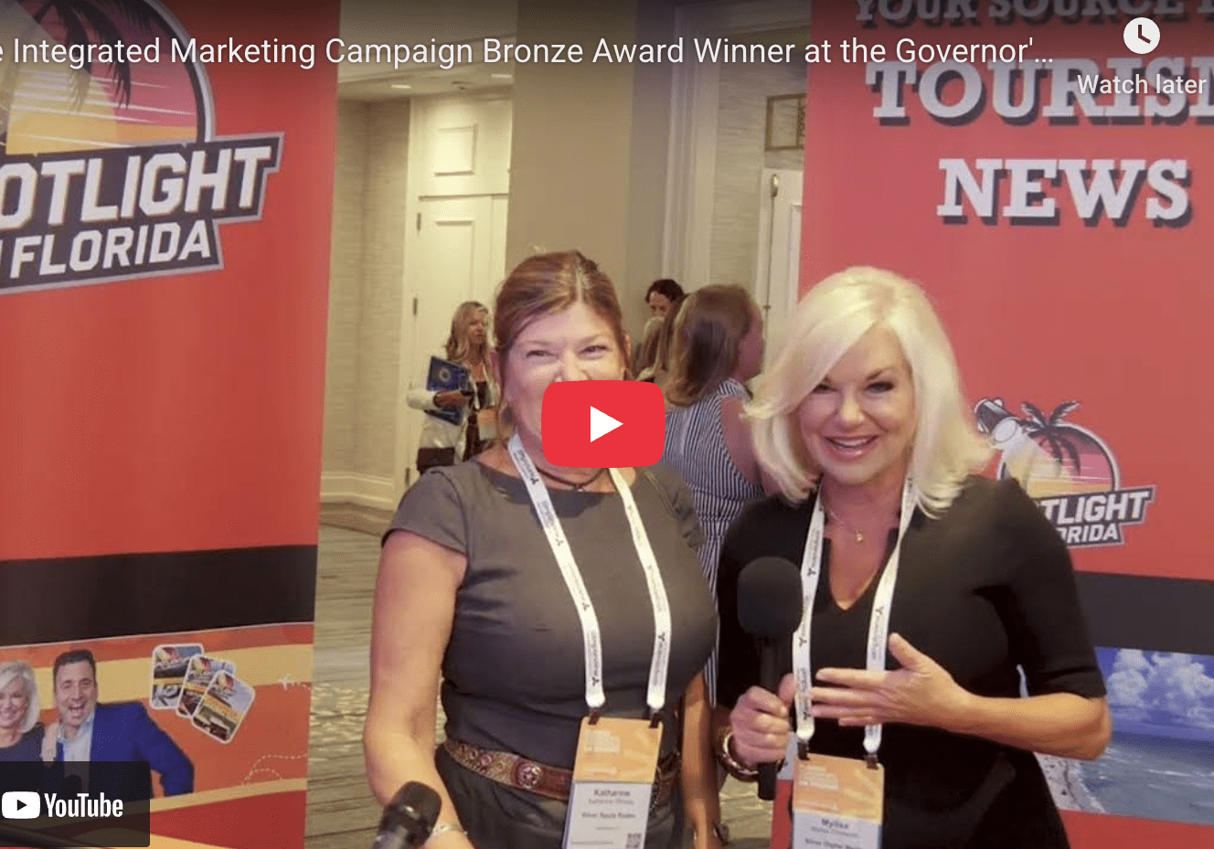 Two women posing at marketing event.