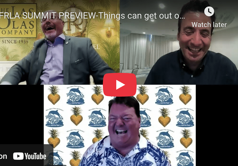 Three men laughing during a video call.