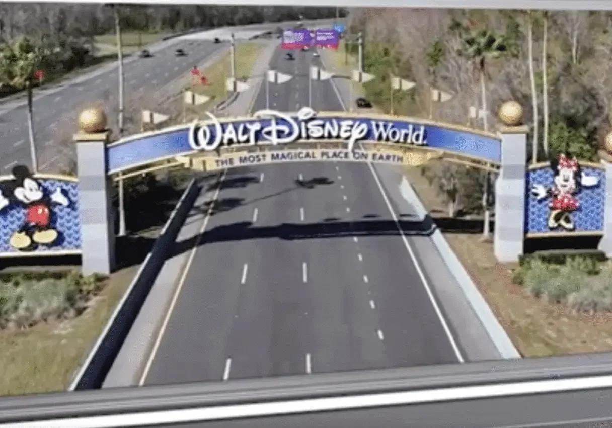 Walt Disney World entrance sign over road.